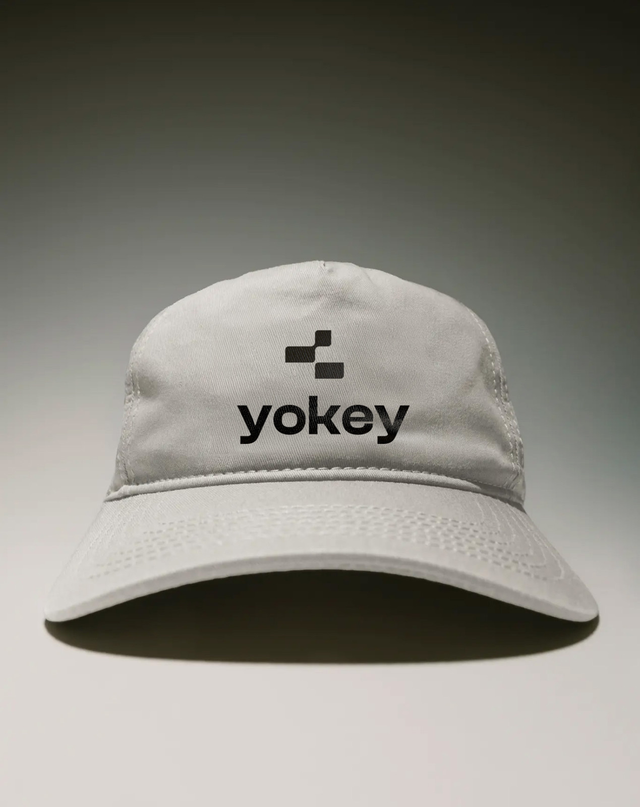 Yokey logo embroidered on a cream cap